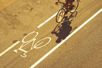 Above view of anonymous cyclist riding in a designated bicycle lane in an urban city.