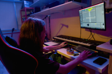 Male composer making music or song on computer