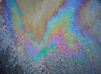 Color Gasoline fuel spots on Asphalt Road as Texture or Background. Environmental pollution concept