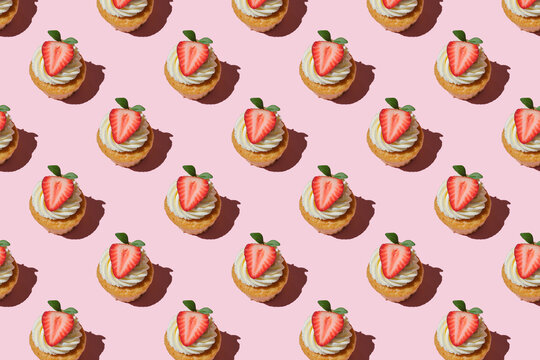 Pattern Made Of Home Cookies With Strawberries And Cream On A Pink Background. Cupcake With Big Strawberry On Top. Repeating  Homemade Cookies With Strawberries And Cream Pattern. Flat Lay Style.