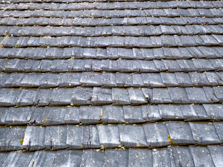 Old rustic wooden roof tiles background texture.