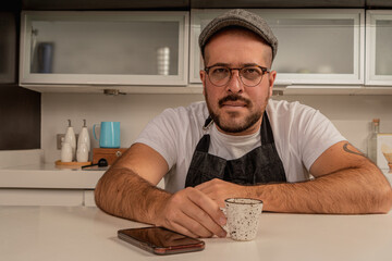 Coffee shop owner waits to take an order and drink a espresso coffee