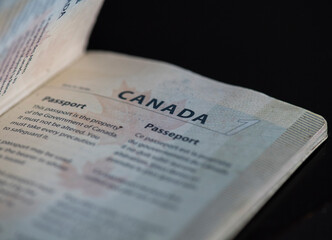 A Canadian passport on a black background.
