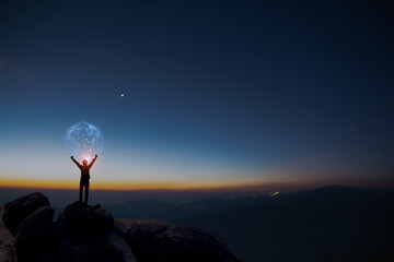 Earth in human hands. earth day. energy saving, Man raise hand up on top of mountain with sunrise...