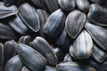 Close-up of black sunflower seeds. texture, background of natural and healthy snacks. Macro photography with shallow depth of field