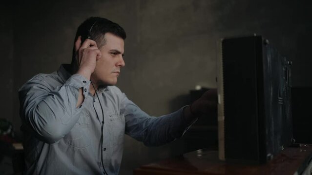 Special Secret agent adjust the technique the reel tape recorder. Officer wiretapping in headphones. KGB spying on conversations.