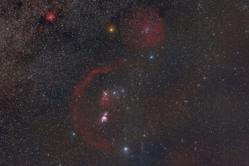 wide field of constellation of Orion with Orion Nebula, flame nebula, barnard's loop and horse head emission nebula on the starry night sky