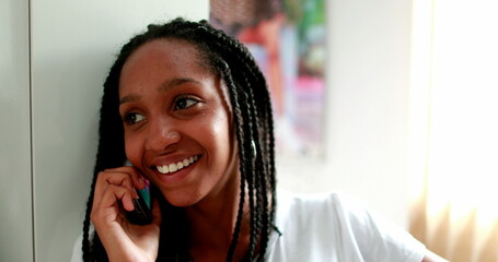 Black girl speaking on phone. African teenager speaks on smartphone