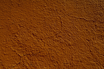 rust colored orange stucco texture wall in antique Mexican construction texture