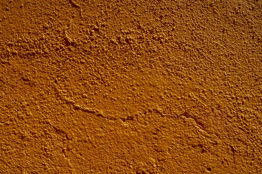 rust colored orange stucco texture wall in antique Mexican construction texture
