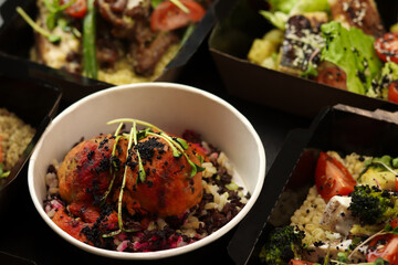 Balanced box diet. Menu suggestions in catering with delivery. Ready healthy food menu in lunch boxes with fish and vegetable packages as daily courier delivery diet plan on black background.