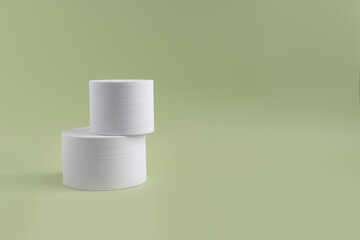 White geometric shapes on a green dull background with space for text and design. Minimalistic composition of white geometric shapes cube. Abstract composition for any text. Blog on any topic. 