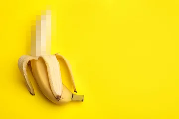 Fresh banana on yellow background, top view with space for text. Safe sex © New Africa