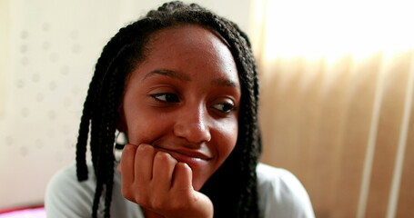 Fototapeta na wymiar African black girl feeling regret emotion. Teenager having mixed feelings