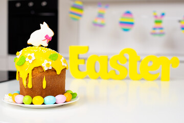 Easter cake with a rabbit and painted eggs on the table. Religious holiday