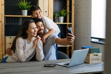 Happy multiethnic family. Mixed race parents helping teenager kid in home schooling.