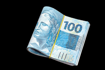 hundred reais banknotes, bundle of money, large amount, debt or financing concept, isolated black...
