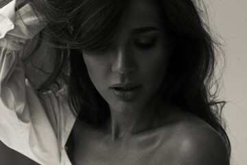 Black and white smiling woman in blouse.