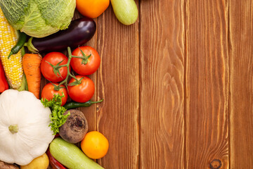 Top view of various vegetables on a wooden table with copy space. Concept of healthy food. Organic vegetables on wooden background
