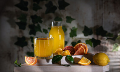 Glass of fresh orange juice with fresh fruit on a wooden table Still life with fresh orange juice...