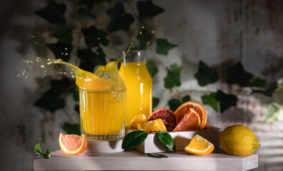 Glass of fresh orange juice with fresh fruit on a wooden table Still life with fresh orange juice...