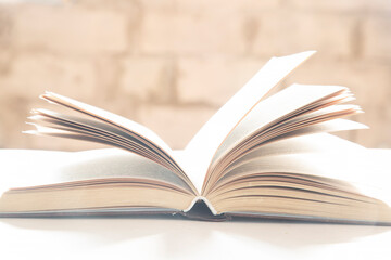 Paper books.A person reads paper books on a table.