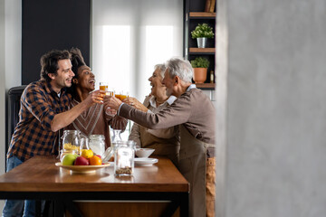 Multi Generation Family Enjoying Meal At Home Together
