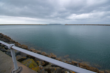 Fototapeta na wymiar Dun Laoghaire port entry with West pier and East pier light houses