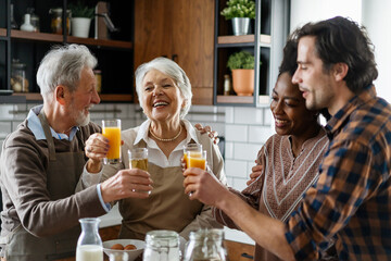 Multi Generation Family Enjoying Meal At Home Together