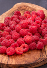 Fresh and tasty looking raspberries on a wooden table