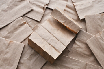 A top view image of several small brown paper lunch bags. 