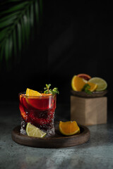 Refreshing sangria or punch with citrus orange lemon fruit in glasses . Sangria of red wine with ice. Traditional Spanish sangria . Drops from a squeezed orange