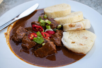 Traditional Czech Beef Goulash meal on a plate with bread