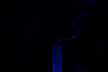blue smoke of an extinguished candle. extinguished candle on a black background. smoke from an extinguished candle on a black background - Powered by Adobe