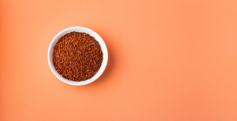 Red quinoa seeds in bowl - Chenopodium quinoa
