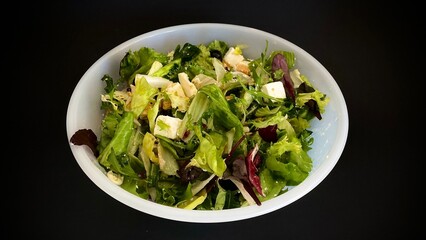 Chicken salad. Chicken caesar salad on black background