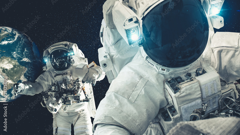 Wall mural astronaut spaceman do spacewalk while working for spaceflight mission at space station . astronaut w