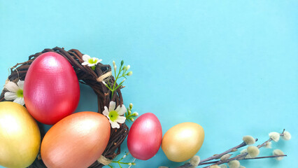 Easter background with Easter eggs, pussy willow, nest and flowers.