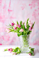 Fototapeta na wymiar spring tulips on pink background. Greeting card for mothers day