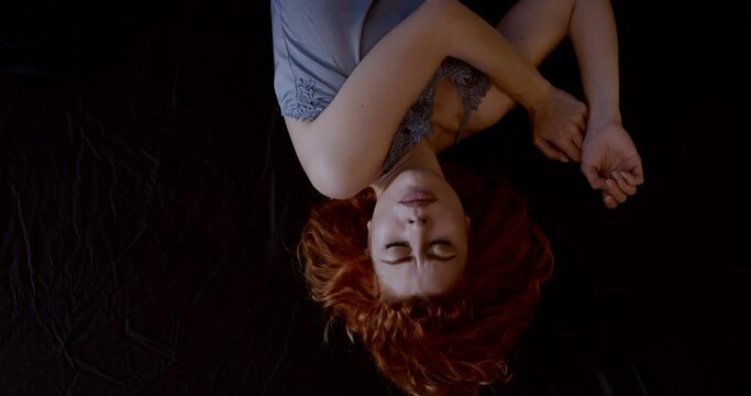 restless night - beautiful woman in nightie fidgeting in her sleep