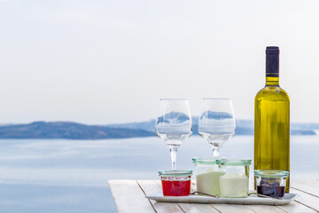 A bottle of white wine served together with greek yoghurt, Oia, Santorini island, Greece