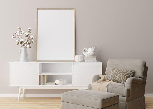 Empty vertical picture frame on cream wall in modern living room. Mock up interior in minimalist, scandinavian style. Free, copy space for picture. Console, armchair, cotton plant, vase. 3D rendering.