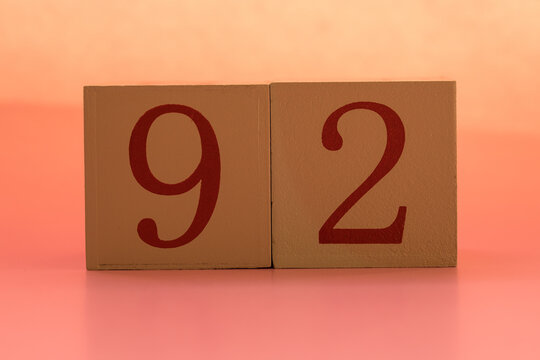 Numbers or dates on wooden cubes, ninety-two