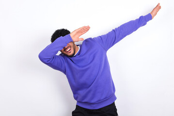 Photo of funky young arab man with curly hair wearing purple sweatshirt over white background show...