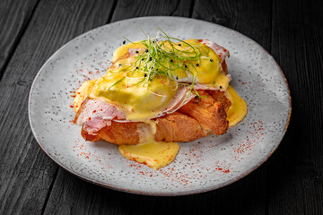Croissant sandwich with chicken fillet, egg, ham and cheese. Healthy, tasty, nourishing snack. Take away food