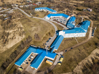 Aerial view of hospital with blue roof in sunny spring day. Kuldiga, Latvia.