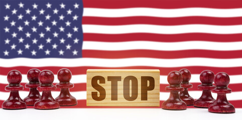 Against the background of the US flag pawns and a sign with the inscription - stop