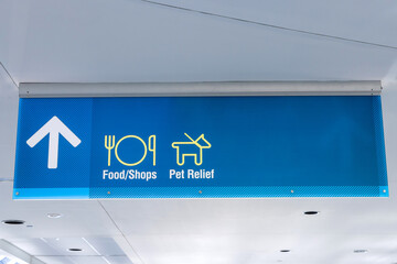 International Airport Sign Food Shops Pet Relief in interior air terminal