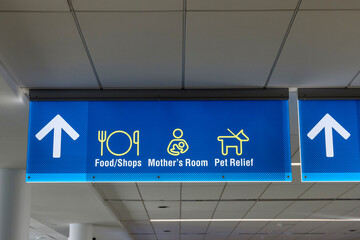 International Airport sign Food Shops Mothers Room Pet Relief in air terminal