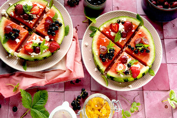 Fresh summer salad with berries and fruits on watermelon with feta cheese